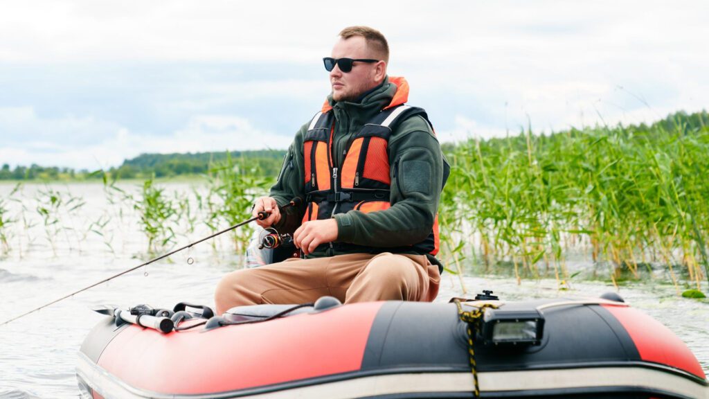 Wearing life jacket while fishing in floating tube.